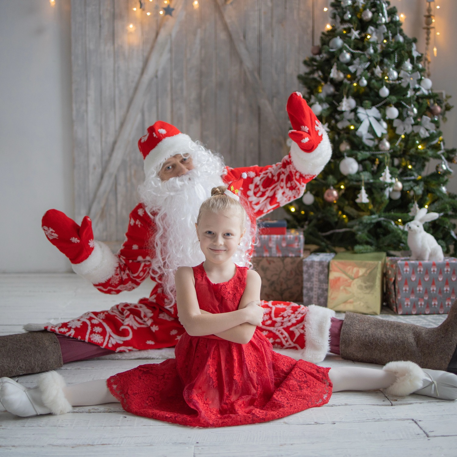 Santa Claus with child at Christmas tree